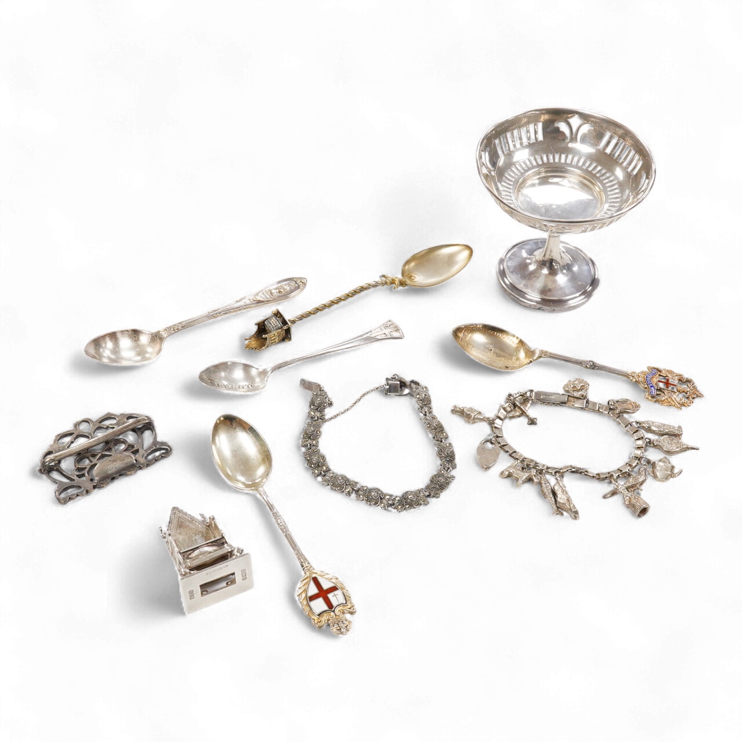 A small group of silver including an Edwardian miniature model of a throne by Edward Foligne Braham, Birmingham, 1901, 50mm, a small comport, one part of a belt buckle and three commemorative spoons, together with a gilt